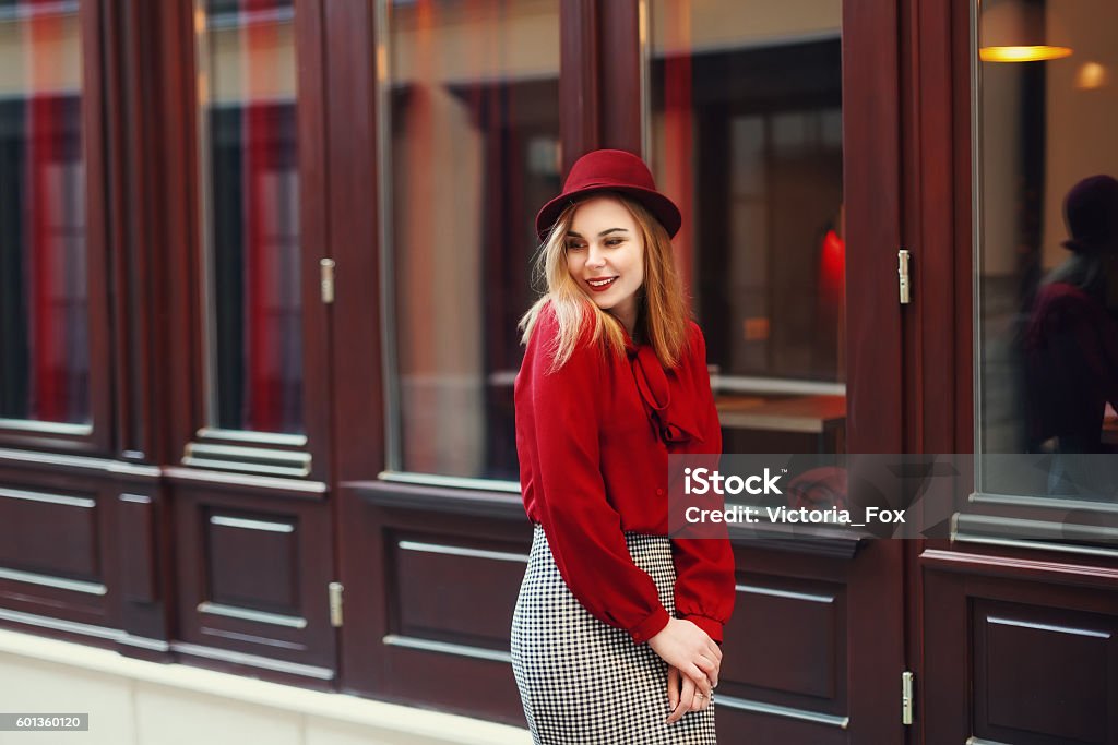 Street portrait of young beautiful happy smiling woman wearing stylish Street portrait of young beautiful happy smiling woman wearing stylish classic clothes. Model looking aside. Female fashion concept. Copy space, free text. Toned. Women Stock Photo