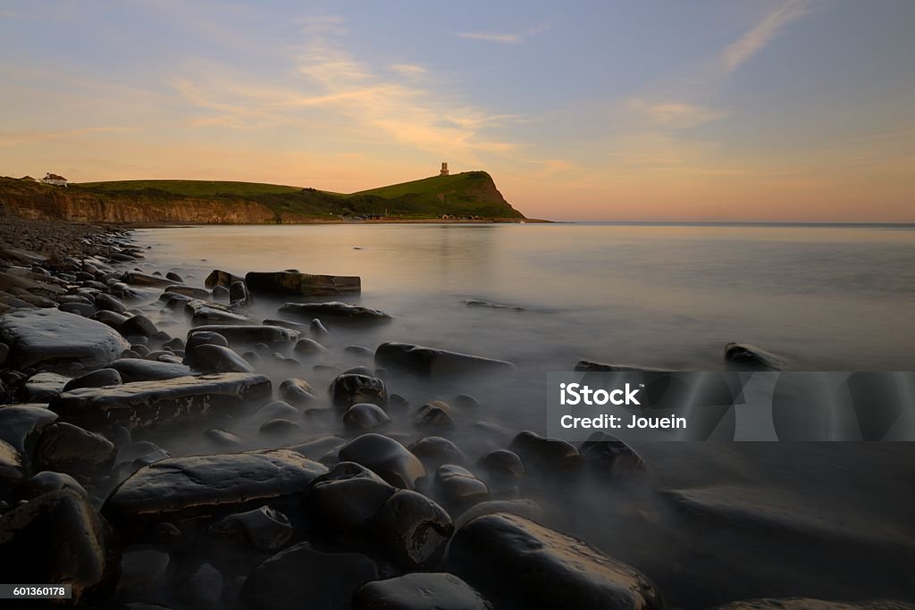 Kimmeridge Bay Sunset Summer Sunset at Kimmeridge Bay. Long exposure to blur the water movement between the rocks. Art Stock Photo