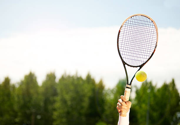 istock Close up of raised tennis racket 601360256