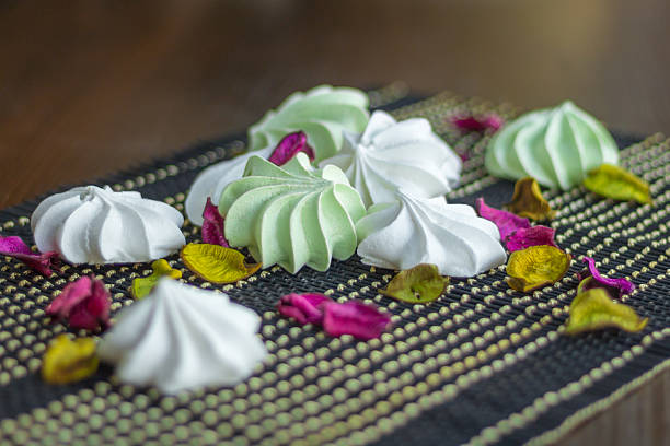 istock White and green marshmallow sweet dessert composition on black background 601361340