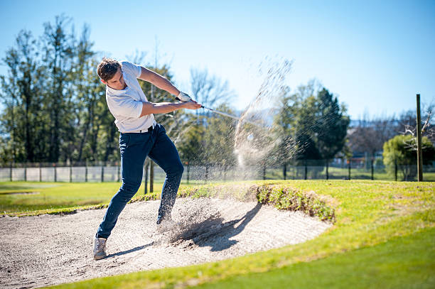 istock golfer playing a chip shot onto the green 601361364