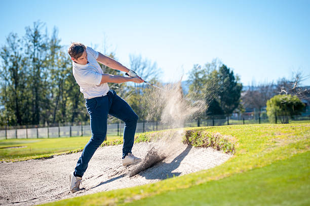 istock golfer playing a chip shot onto the green 601361582