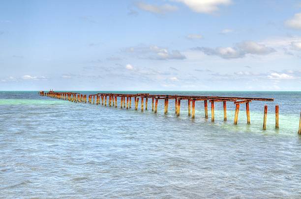 Cuban beach train rails in sea white sand holidays vacation stock photo
