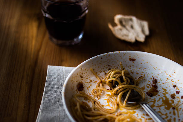 istock unfinished meal of spaghetti with beverage and bread. 601362002