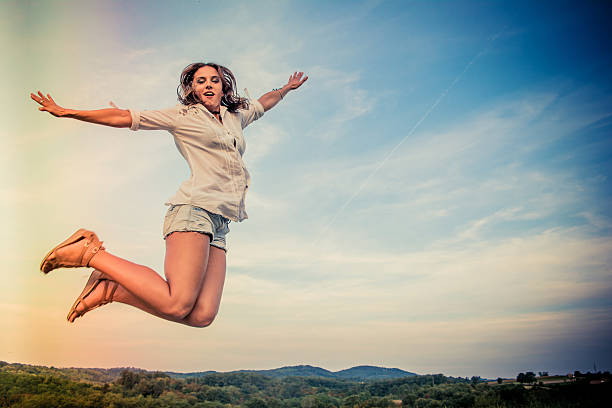 istock Young woman jumping outdoors 601362574