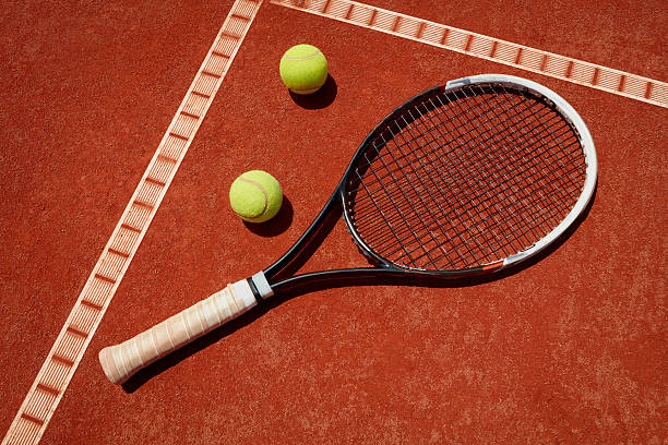 istock Close up racket and balls on tennis terrain 601364226