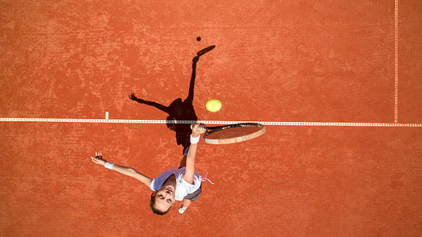 istock Tennis player hitting ball on tennis terrain 601364594