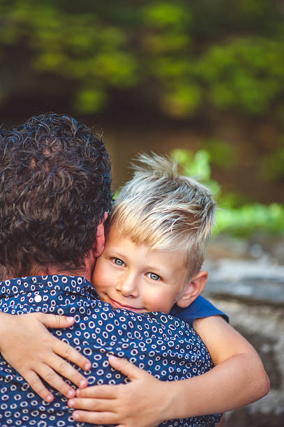 istock Little Boy Hugging His Father 601364928