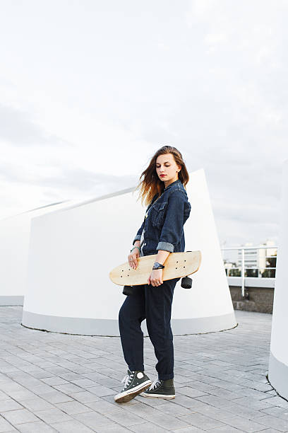 istock Young hipster girl with longboard 601364948