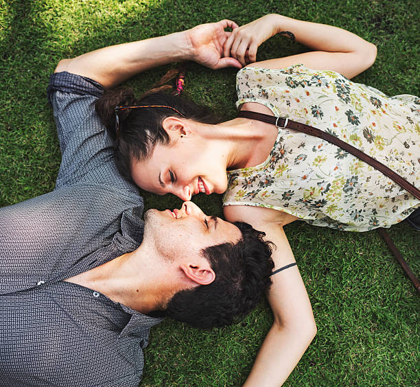 istock Sweet Couple Laying Grass Concept 601365124
