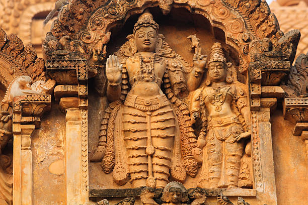 Ancient bas relief. Brihadishwara Temple. Tanjore (Thanjavur) Bas-relief is a type of sculpture that has less depth to the faces and figures than they actually have, when measured proportionately (to scale). This technique retains the natural contours of the figures, and allows the work to be viewed from many angles without distortion of the figures themselves.Brihadeeswarar Temple.Brihadishwara, brihadeeswarar, brihadishwara. dravidian culture stock pictures, royalty-free photos & images