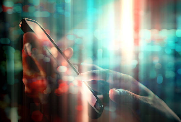 istock using cell phone in abstract city background double exposure 601365718