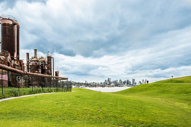 Seattle, USA - April 15, 2016: Gas Works Park and skyline or cityscape with Space Needle and People on hill with overcast, stormy sky