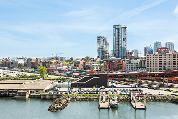 City downtown skyline or cityscape with industrial port Vancouver, Canada - April 19, 2016: City downtown skyline or cityscape with industrial port with cars, cargo, containers and trains on Harbour east vancouver stock pictures, royalty-free photos & images