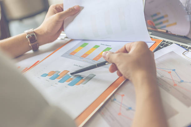 istock Asian office employee checking sales report at workplace 601368146