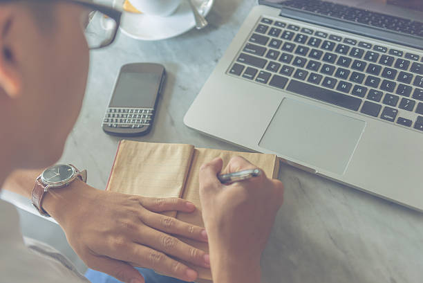 istock Young businessman writing important appointment to his diary 601368236