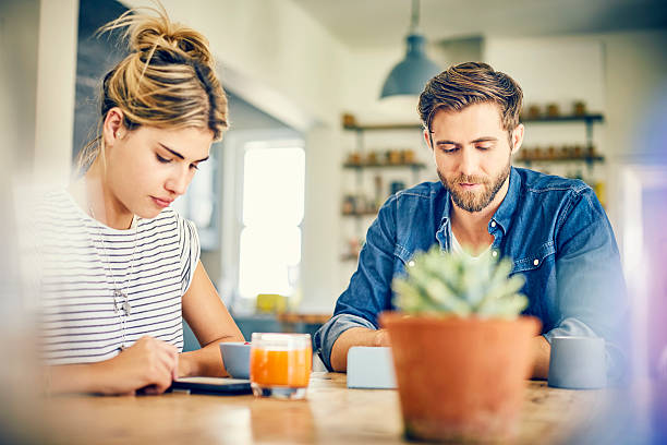 istock Male and female bloggers using digital tablets at table 601368816
