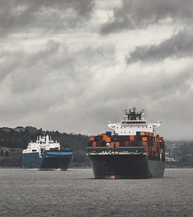 Two container ships are anchored in Halifax`s Bedford Basin awaiting their berth at the container terminal.