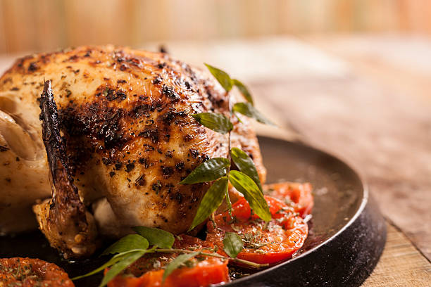 istock Roasted chicken, turkey with tomatoes in iron skillet. 601368992