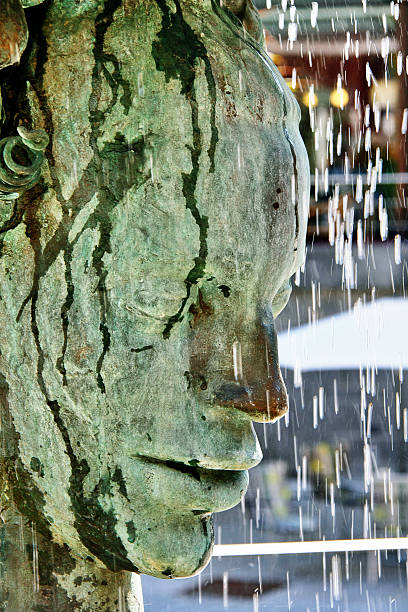 Bohemia, Karlovy Vary, Czech - May 22, 2011 - Crying fountain Bohemia, Karlovy Vary (Carlsbad), Czech Republic - May 22, 2011 - Two faces Janus fountain, crying fountain with hot mineral water. janus head stock pictures, royalty-free photos & images