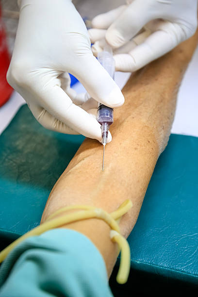 istock Shot of human hands making an injection with a syringe 601371266