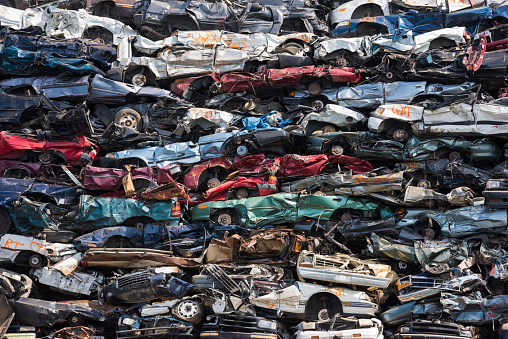 Crushed cars stacked up for recycling
