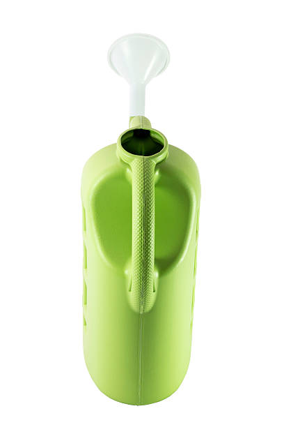 istock Green plastic watering can isolated on white background. 601374558