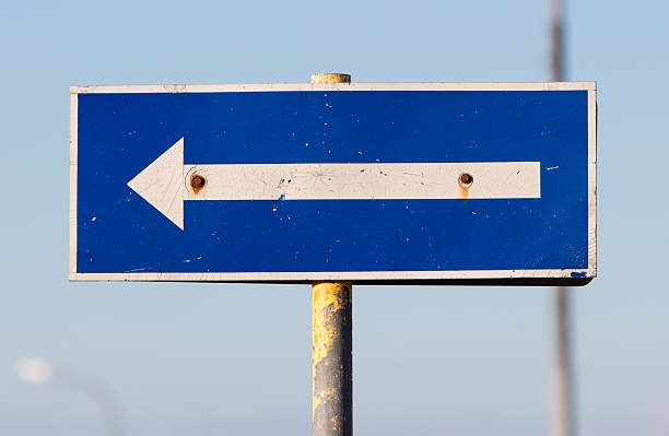 istock Traffic sign arrow pointing left, sign on an abandoned Amarican 601375404