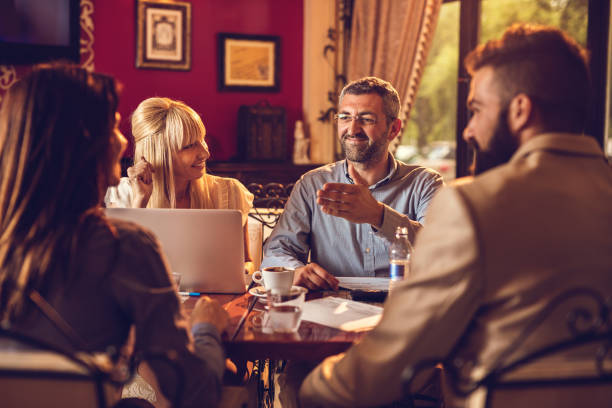istock Smiling business people communicating during meeting in a cafe. 601375616