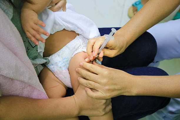 Children receiving vaccine at out side of the thigh.Children vac Children receiving vaccine at out side of the thigh.Children vaccine.Children receiving vaccine at out side of the thigh.Children vaccine. CHIANG MAI, Thailand. deltoid stock pictures, royalty-free photos & images
