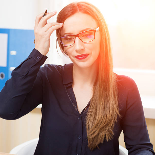 istock Young businesswoman working in office with papers 601376486