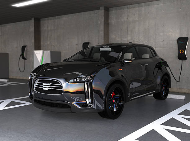 Black electric SUV recharging in parking garage stock photo