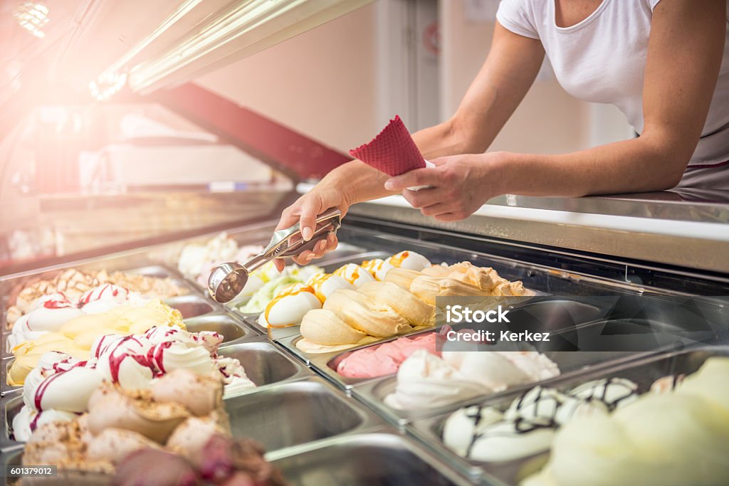 Woman serving ice cream Woman serving ice cream in Confectionery shop Ice Cream Stock Photo