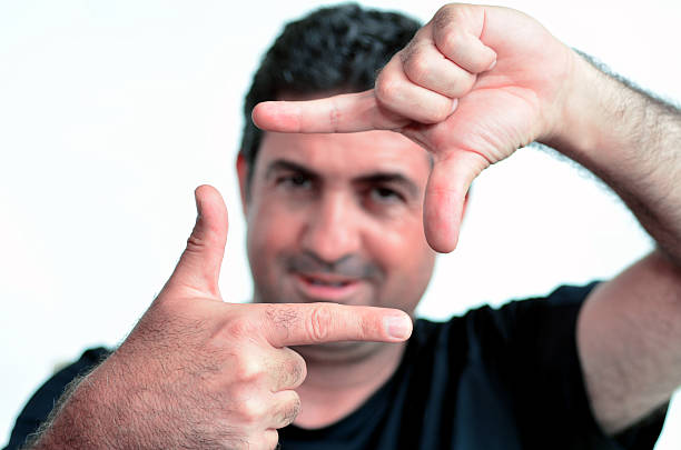 istock Happy mature man creating frame with fingers 601379862