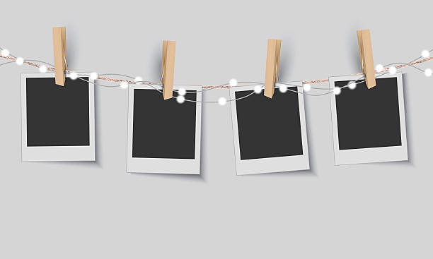 leere bilderrahmen mit lichterketten - hängen fotos stock-grafiken, -clipart, -cartoons und -symbole