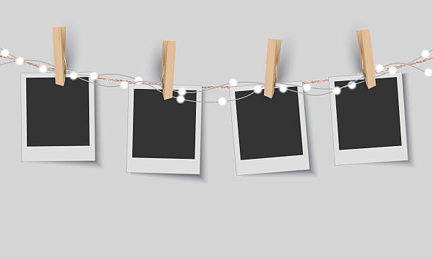 Blank photo frames with fairy lights Vector EPS 10 format. clothespin stock illustrations