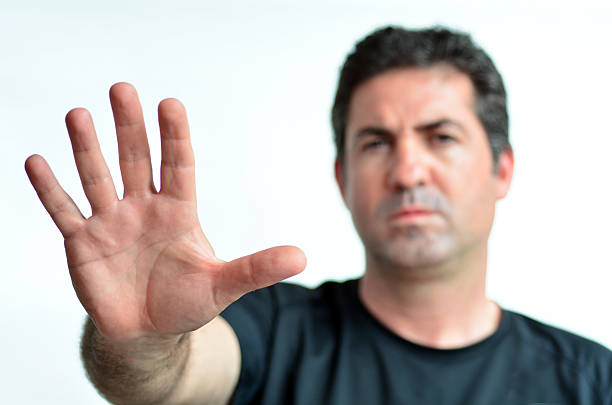 istock Upset mature man show stop sign with his palm. 601380086