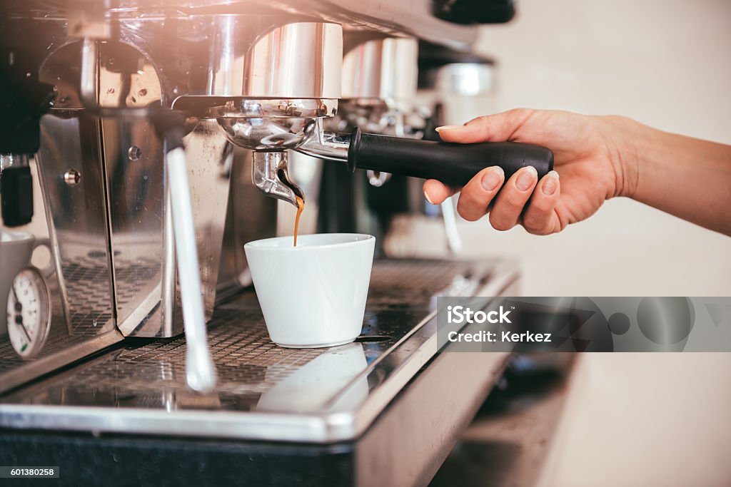 Woman making coffee Woman making coffee by espresso machine Coffee - Drink Stock Photo