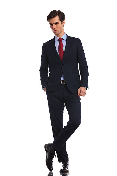 istock relaxed business man standing with legs crossed 601380702