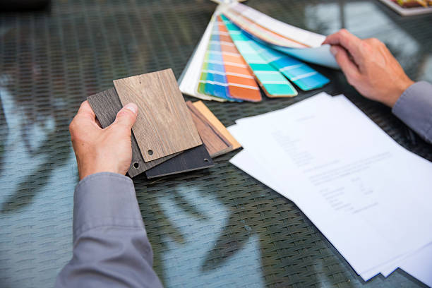 istock Architect holding wood sample and pantone color 601380714
