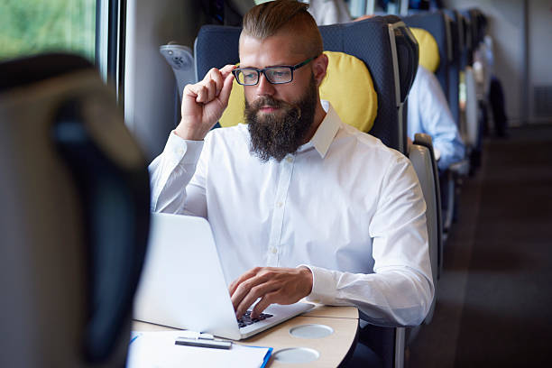 istock Man working on laptop at the train 601381934