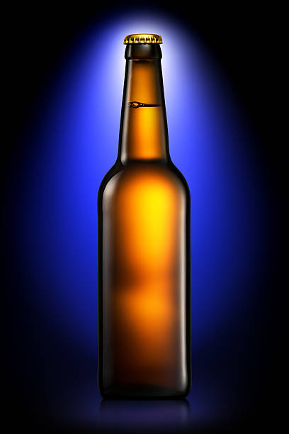 istock Bottle of beer or cider isolated on dark blue background 601382112