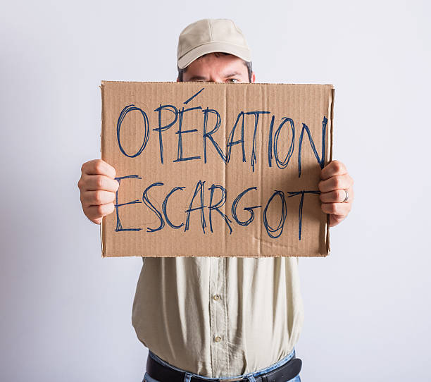 istock Truck driver holding OPERATION ESCARGOT sign 601383590