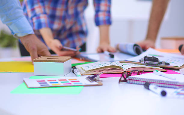 istock Close-up of three young creative designers working on project 601384386