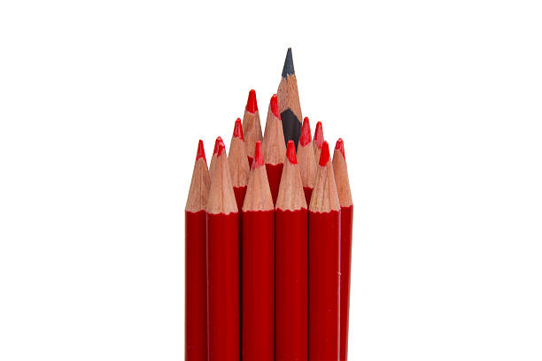 istock Black pencil standing out from the red pencils, isolated 601386716