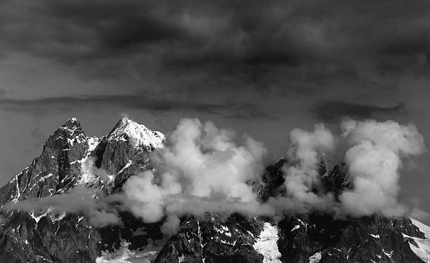 istock Black and white view on Mt. Ushba in clouds 601387408