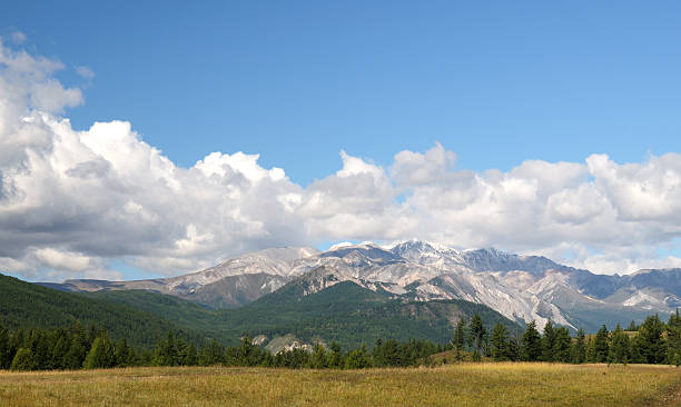 istock Blue sky and cumulus clouds over the Eastern Sayan Mountains 601388666