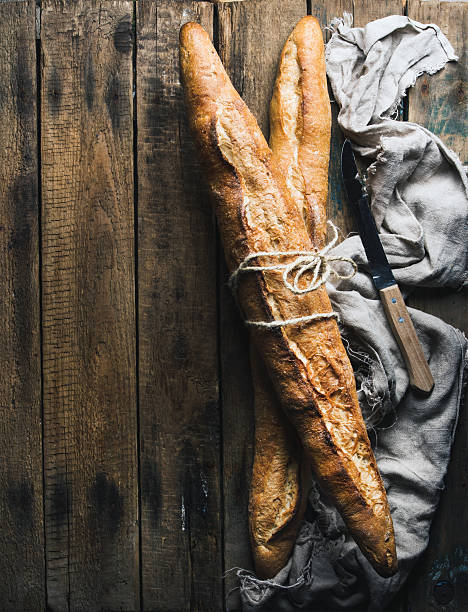 istock French baguettes on rough rustic wooden background 601389312