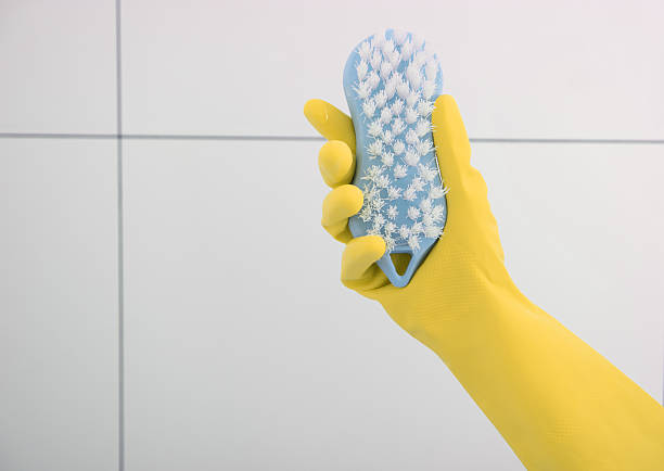 istock Yellow rubber glove with brush. 601391162