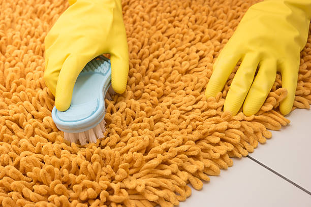 istock Housewife hands cleaning carpet. 601392212